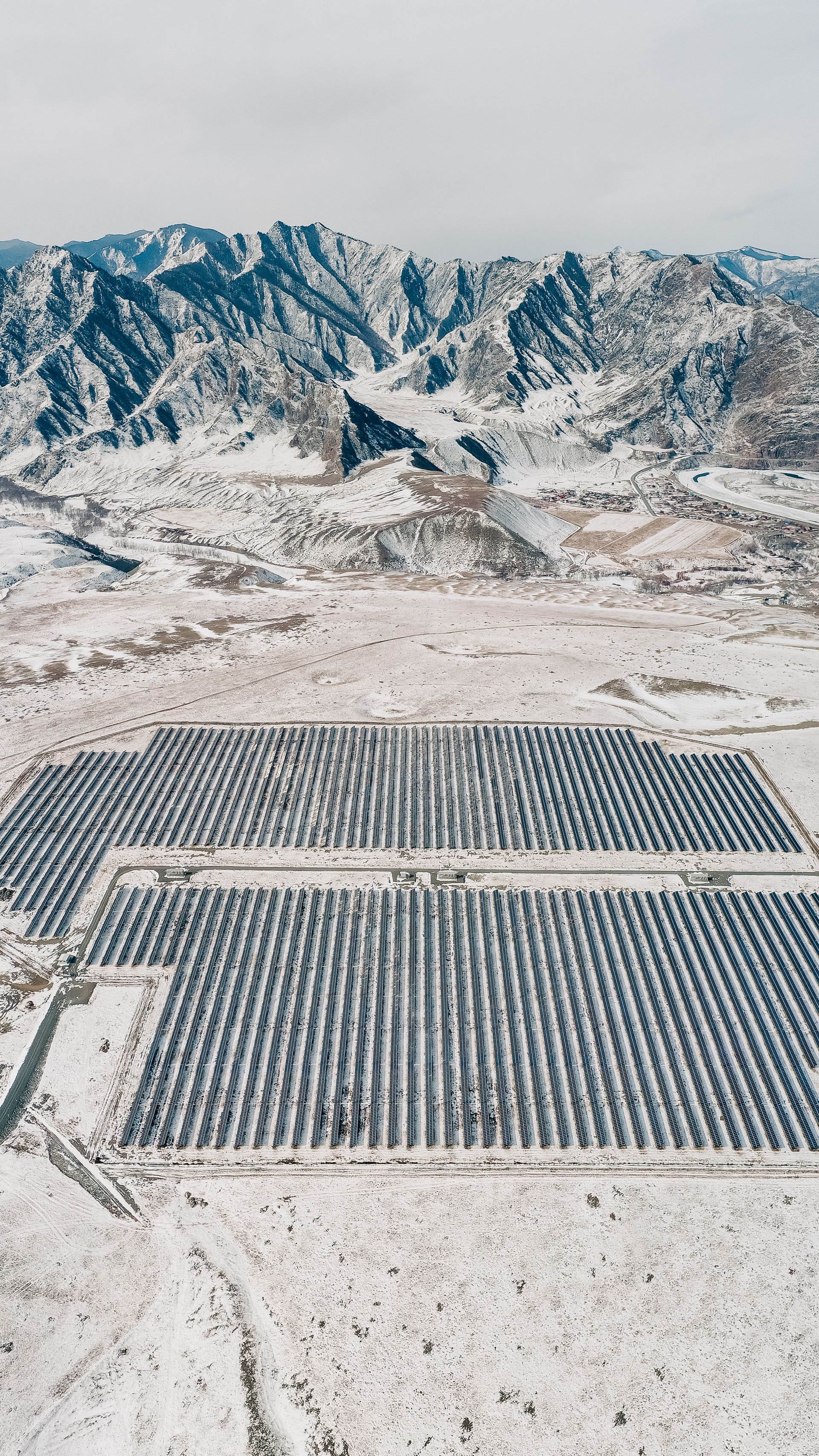 Panoramic view of photovoltaic solar panels installed in front of Spanish mountains